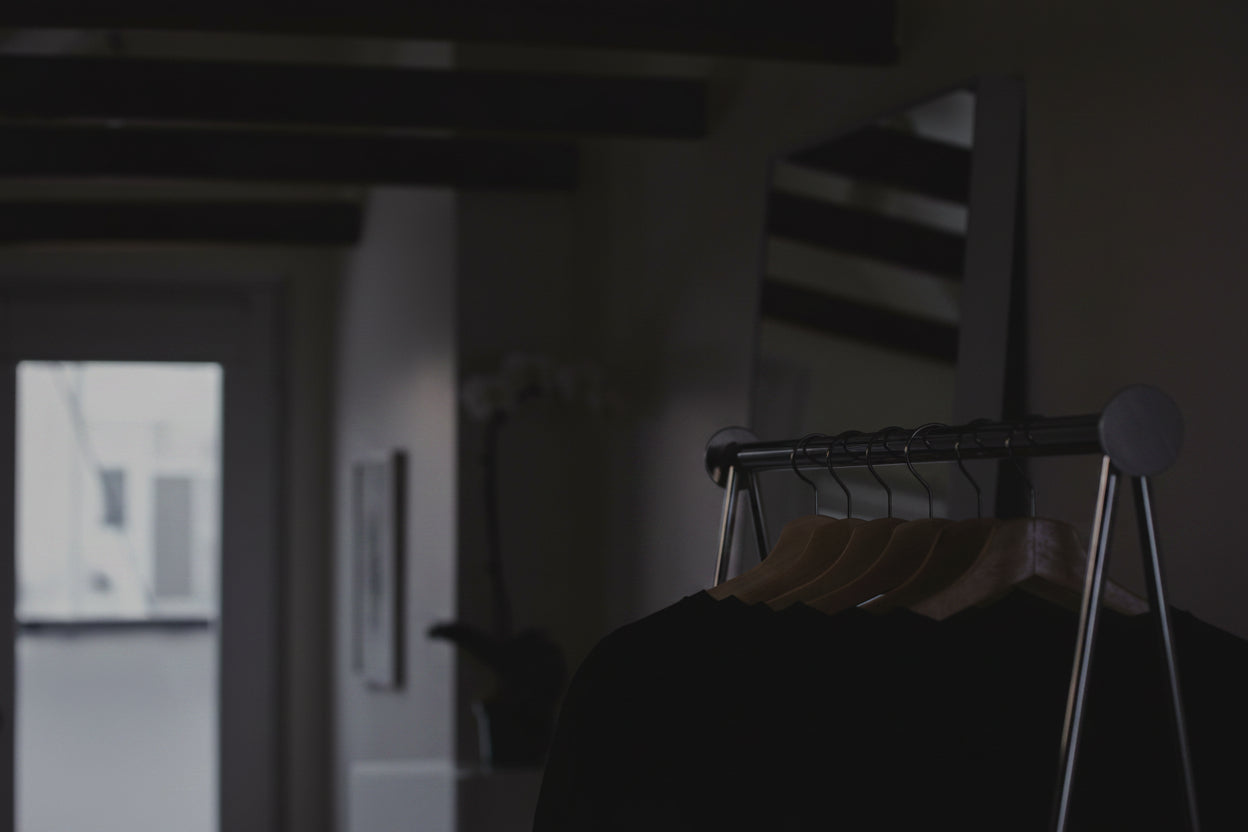 clothing-on-a-shop-rack-with-flowers-in-the-background.jpg